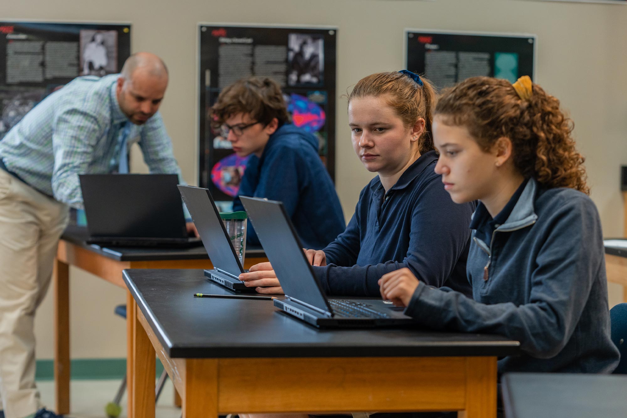 Matt Dakolios working with students at a table