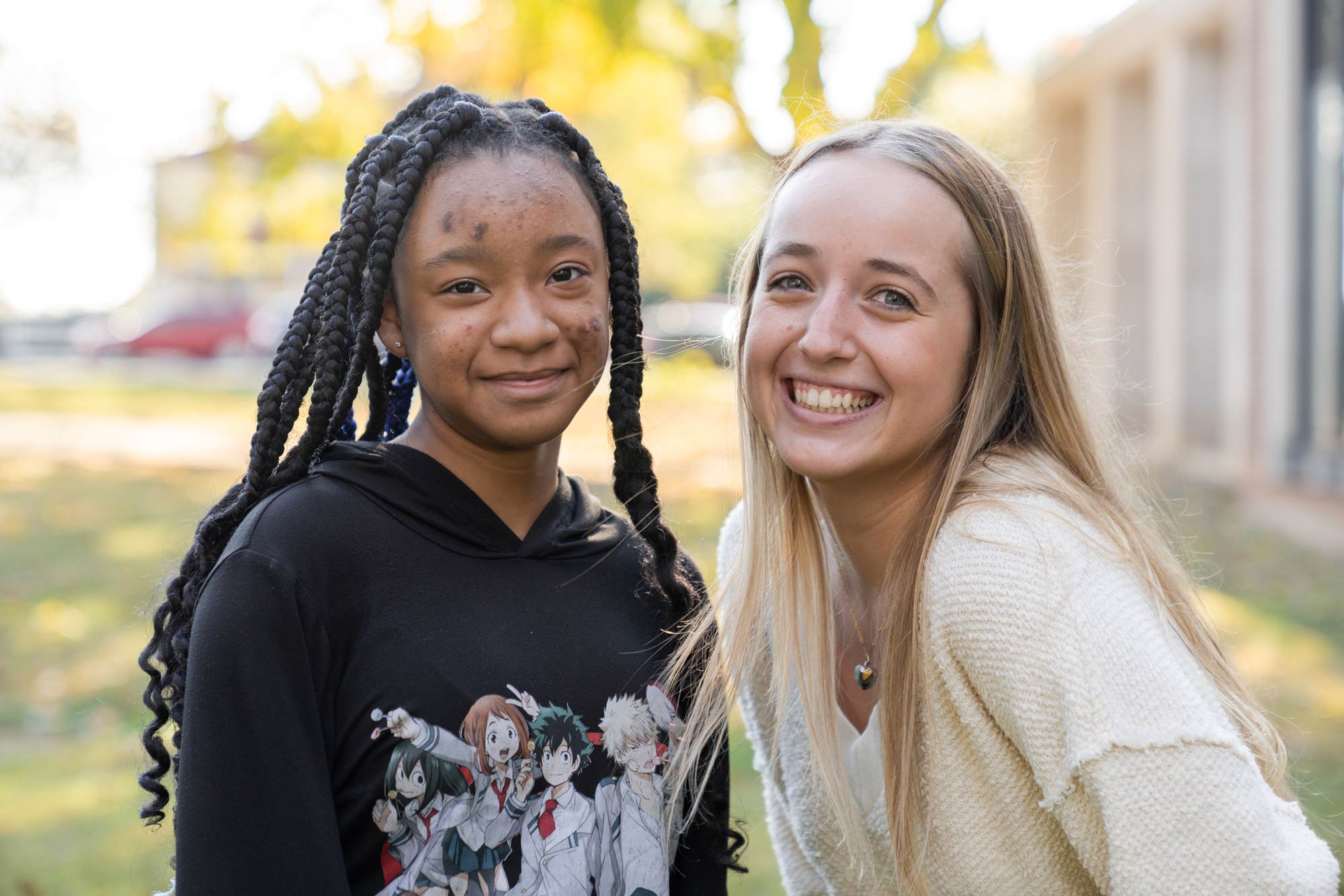 Ella Fendley, right and Khaydence, left stand next to each other smiling at the camera