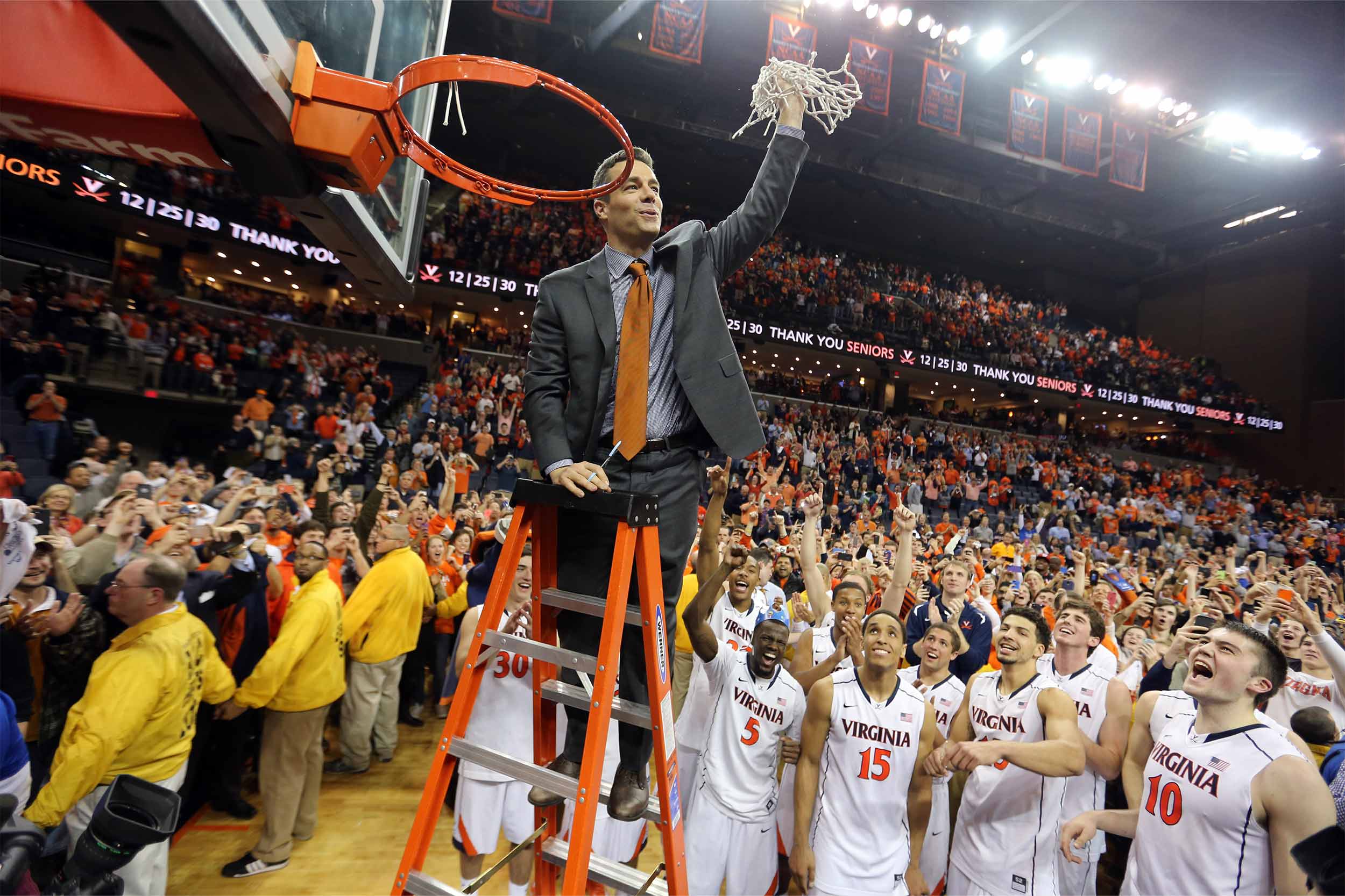 Tony Bennett cutting the winning net off the rim