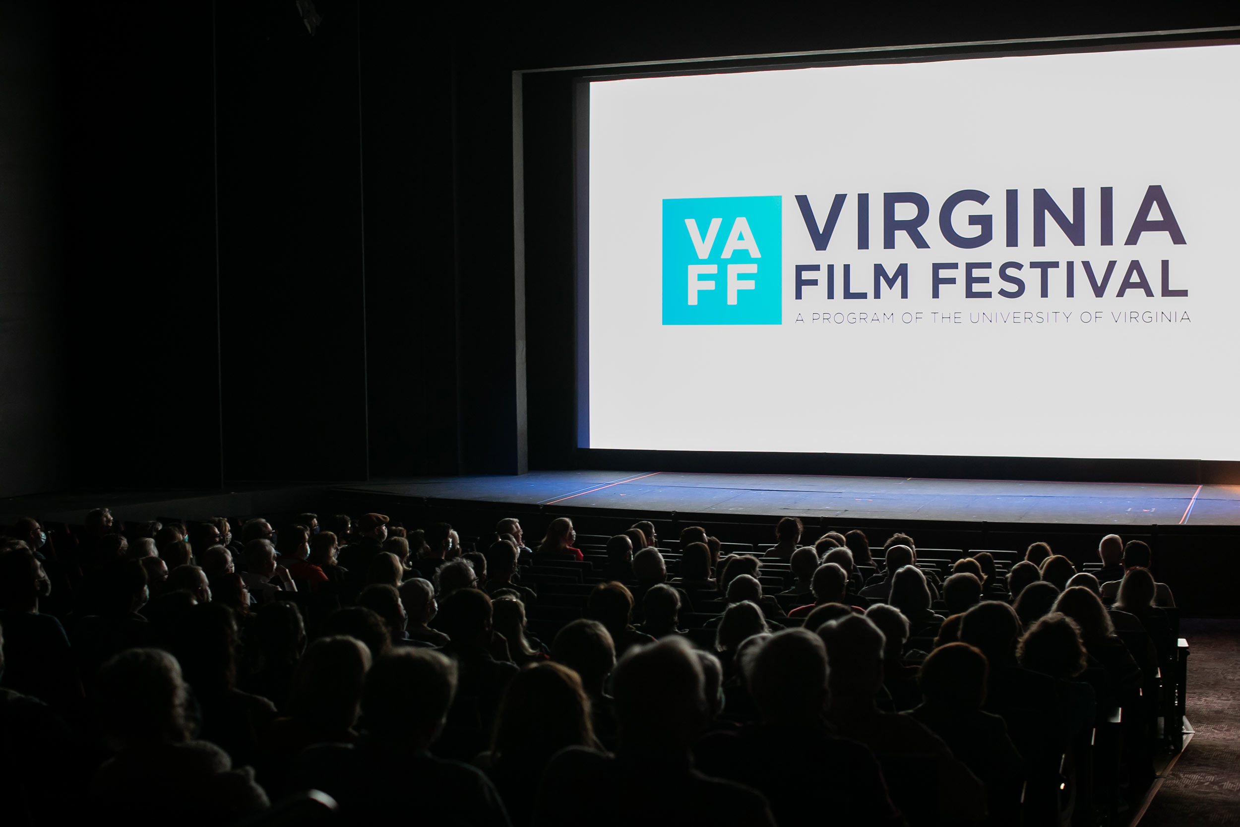 Audience watching a theatre screen that reads Virginia Film Festival