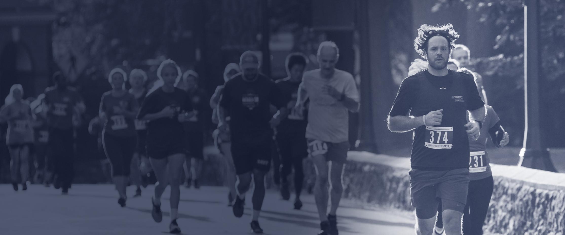 A group of runners running through UVA Grounds with a blue overlay.