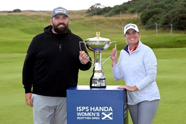 A portrait of UVA alumni John Pond and Lauren Coughlin, celebrating with their medals after winning the ISPS Handa Women’s Scottish Open.