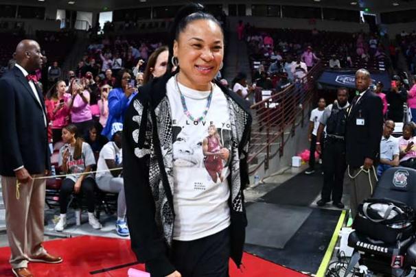 Dawn Staley walks through a crowd sporting meaningful clothing an accessory items.